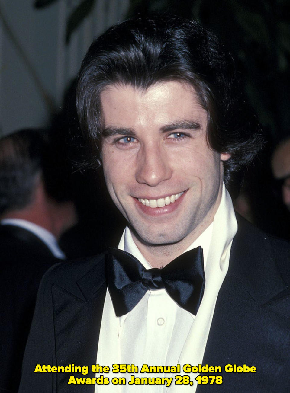 A young Travolta smiling