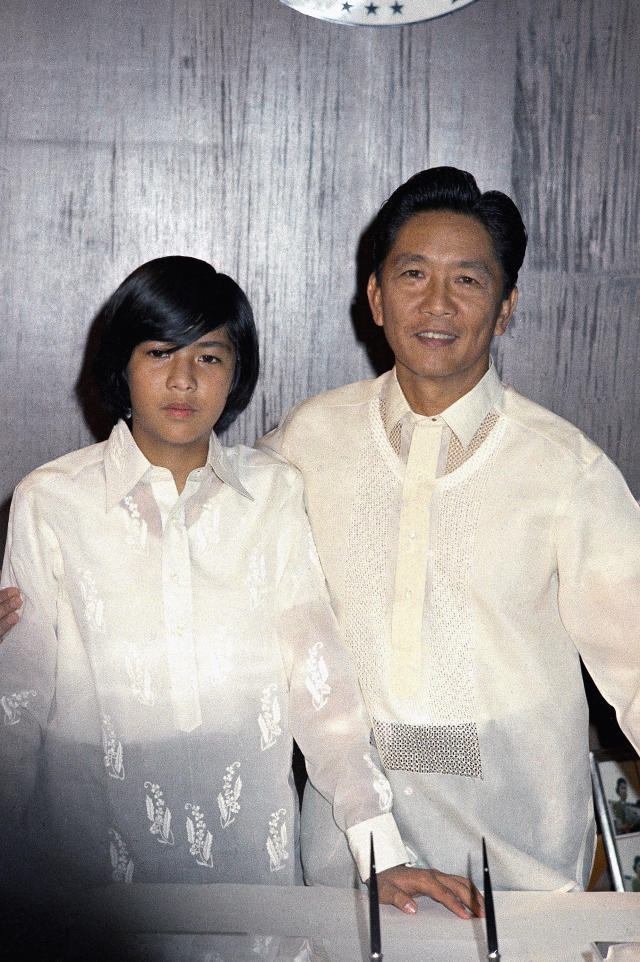 FILE- President Ferdinand Marcos of the Philippines, right, poses with his only son Ferdinand 'Bongbong" Marcos Jr.,on Jan. 18, 1972, in Manila, Philippines. Marcos Jr., son of the late dictator and his running mate Sara, who is the daughter of the outgoing President Rodrigo Duterte, are leading pre-election surveys despite his family's history. (AP Photo/Jess Tan Jr.,File)