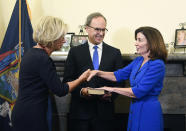 New York Chief Judge Janet DiFiore swears in Kathy Hochul as the first woman to be New York's governor during a swearing-in ceremony in the Red Room at the state Capitol, early Tuesday, Aug. 24, 2021, in Albany, N.Y. (AP Photo/Hans Pennink, Pool)