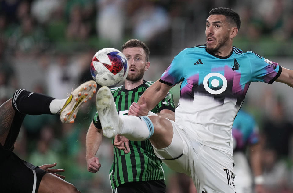 Minnesota United defender Michael Boxall, right, moves the ball past Austin FC forward Jon Gallagher, left, during the second half of an MLS soccer match Wednesday, May 31, 2023, in Austin, Texas. (AP Photo/Eric Gay)