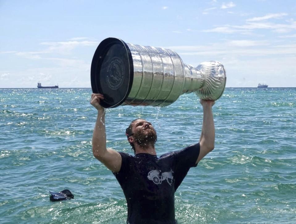 Florida Panthers NHL hockey player Matthew Tkachuk celebrates with the Stanley Cup in the Atlantic Ocean in Fort Lauderdale, Fla., Tuesday, June 25, 2024. The Panthers beat the Edmonton Oilers 2-1 on Monday night in Game 7 of the Stanley Cup Final. (Joe Cavaretta/South Florida Sun-Sentinel via AP)