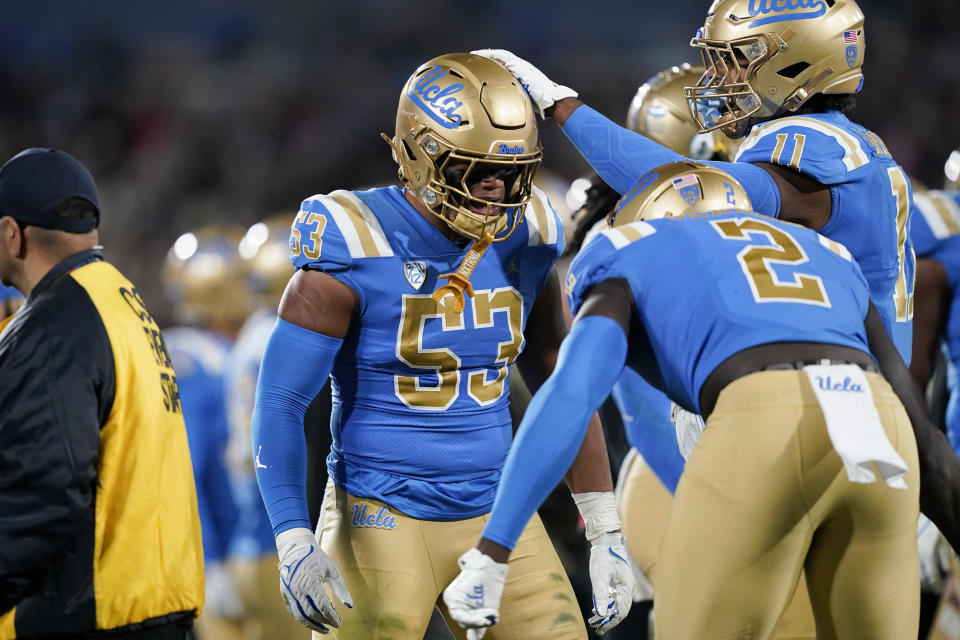 UCLA linebackers Darius Muasau (53) and Oluwafemi Oladejo (2) and defensive lineman Gabriel Murphy (11) celebrate after a stop of Arizona State during the first half of an NCAA college football game Saturday, Nov. 11, 2023, in Pasadena, Calif. (AP Photo/Ryan Sun)