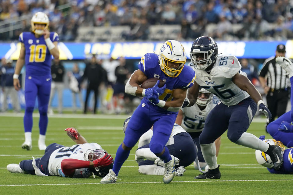 Los Angeles Chargers running back Austin Ekeler, middle, runs against the Tennessee Titans. (AP Photo/Marcio Jose Sanchez)