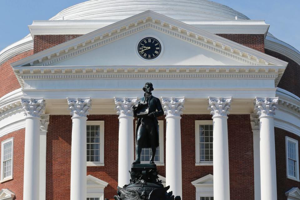 A statue of Thomas Jefferson stands in front of the Rotunda on the campus of the University of Virginia in Charlottesville