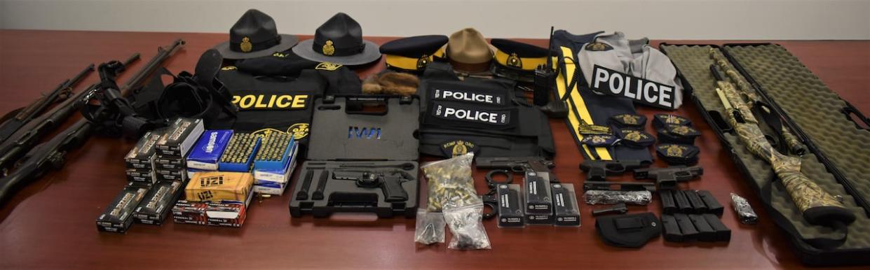 In May 2023, Police said they searched two residences in Millville, N.S., and seized a number of articles of police clothing and equipment that appeared to be authentic, among other things. (Cape Breton Regional Police Service - image credit)