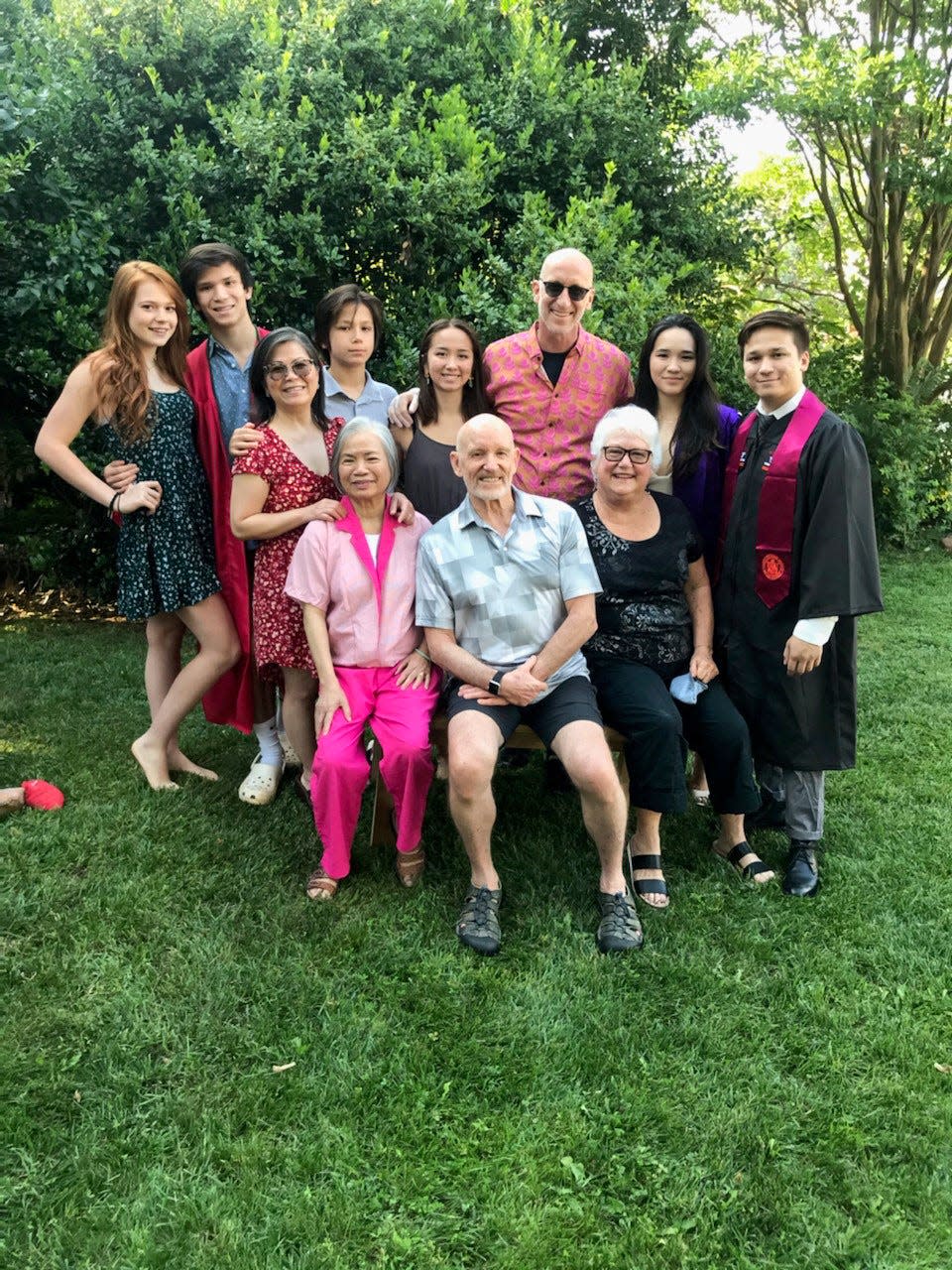 After quarantines and juggling medical recommendations to move college kids back into the family bubble in Northern Virginia in June 2020: In the front row are grandparents Duc Le and Bob and Carol Anne Elston. Back row from left, Fiorella Chrystal, high school grad Kien-Tam, Thuan, son Thai-Son, daughter Thai-Binh, husband Bob, son Hanh-Thien and girlfriend Suzi Kawachi — both new college graduates.