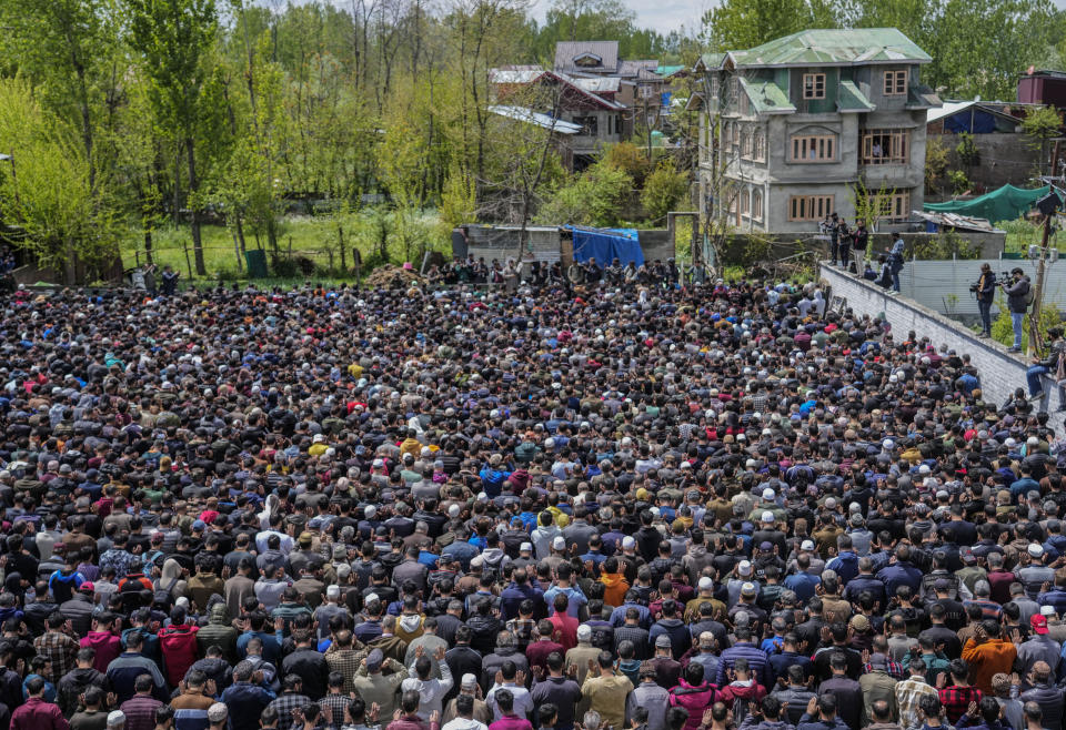 People offer joint funeral prayers near the coffins of victims of a boat capsize on the outskirts of Srinagar, Indian controlled Kashmir, Tuesday, April. 16, 2024. The boat capsized in Jhelum river, most of the passengers were children, and rescuers were searching for many others who were still missing. (AP Photo/Mukhtar Khan)