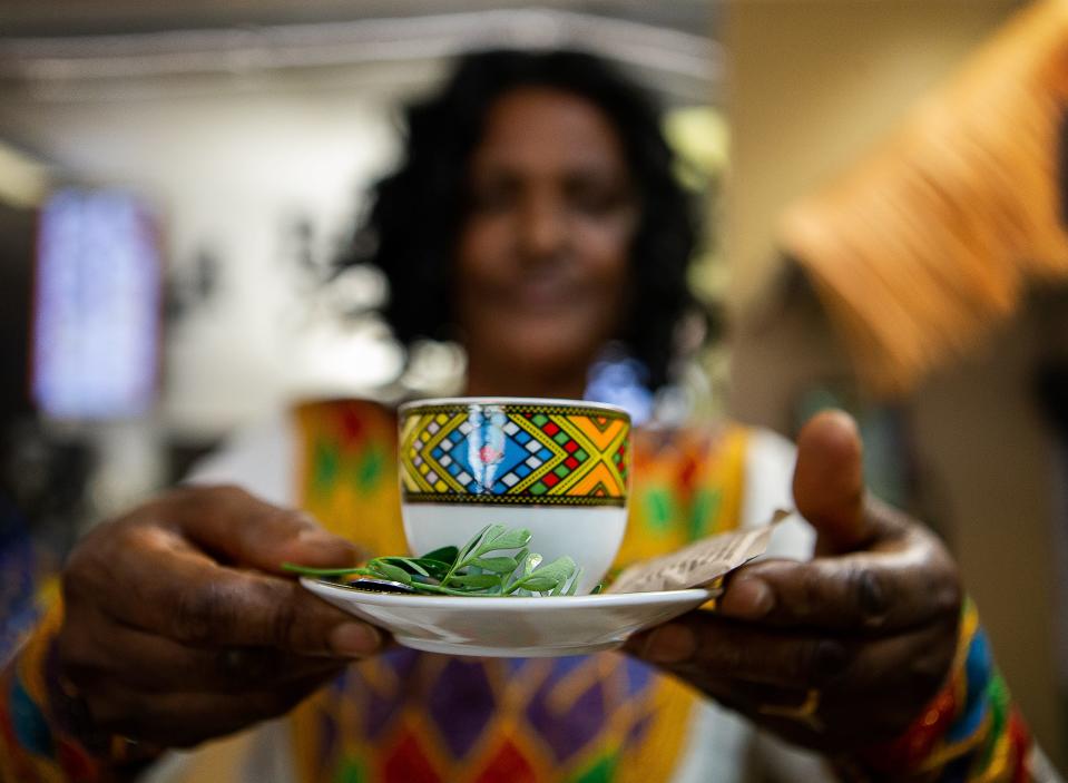 Adanech Sirbabo offered up freshly brewed coffee beans while hosting an Ethiopian Coffee Ceremony for customers at Abol Cafe on Friday afternoon, June 30, 2023.