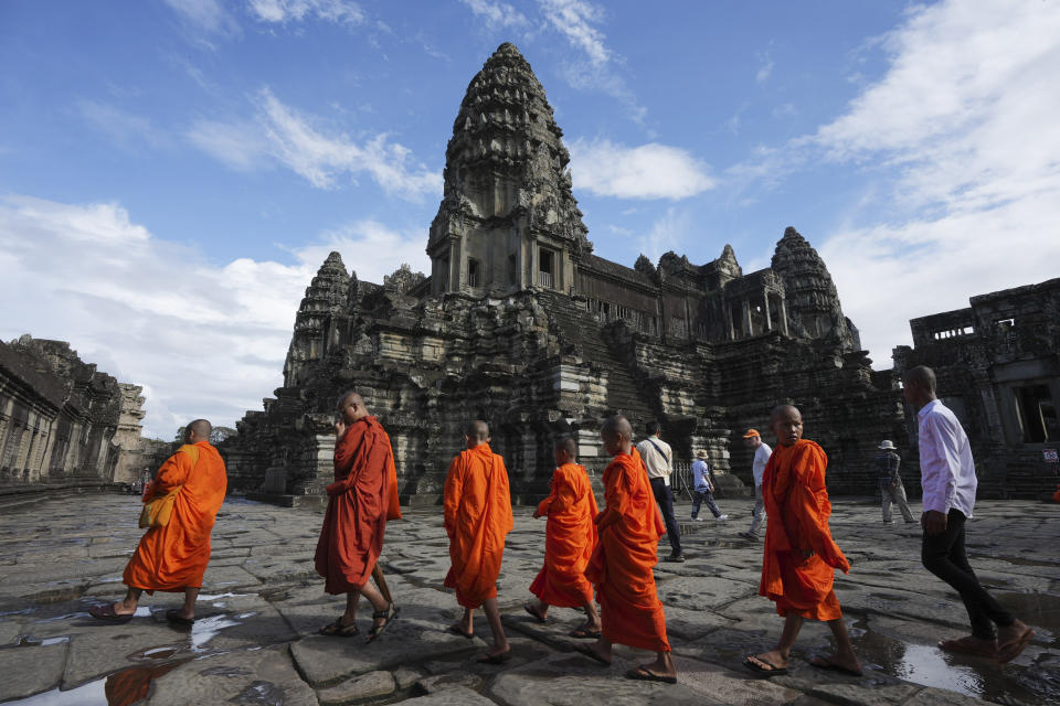 Cambodian Buddhist monks visit the Angkor Wat temple in Siem Reap, Cambodia, Wednesday, Nov. 15, 2023. It's believed Cambodia's main tourist destination, Angkor Wat, was built between the 9th and 15th centuries. (AP Photo/Heng Sinith)