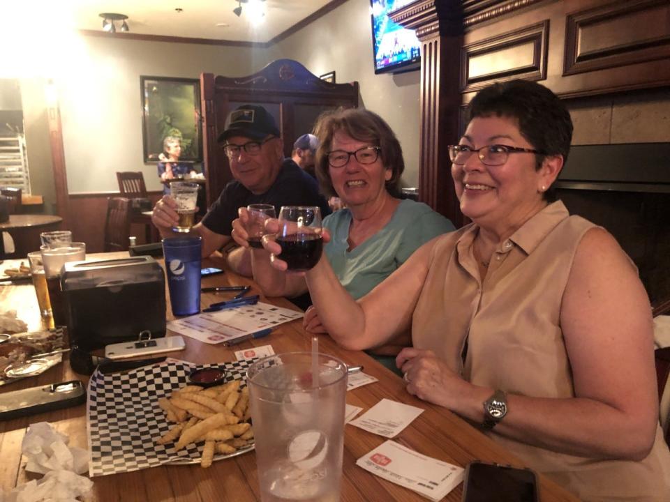 Max Miller, Sandy Sadowski and Dorothy Emory raise their drinks in salute Thursday before playing trivia at AJ's New York Style Pizzeria.