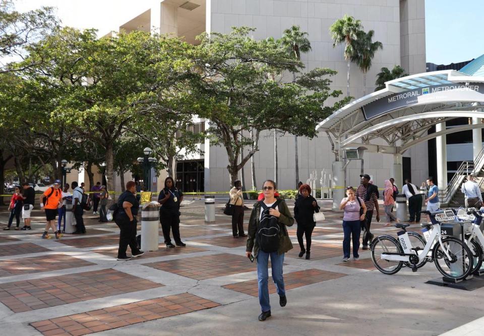 Pedestrians walk pass the closed Stephen P. Clark Center as City of Miami Police and Fire&Rescue responded and evacuated Stephen P. Clark Center after tremors were reported due to a 7.7 magnitude earthquake struck between Cuba and Jamaica shortly after 2:00 pm today.