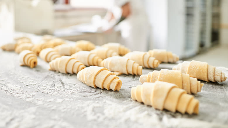 Unbaked croissants on metal table