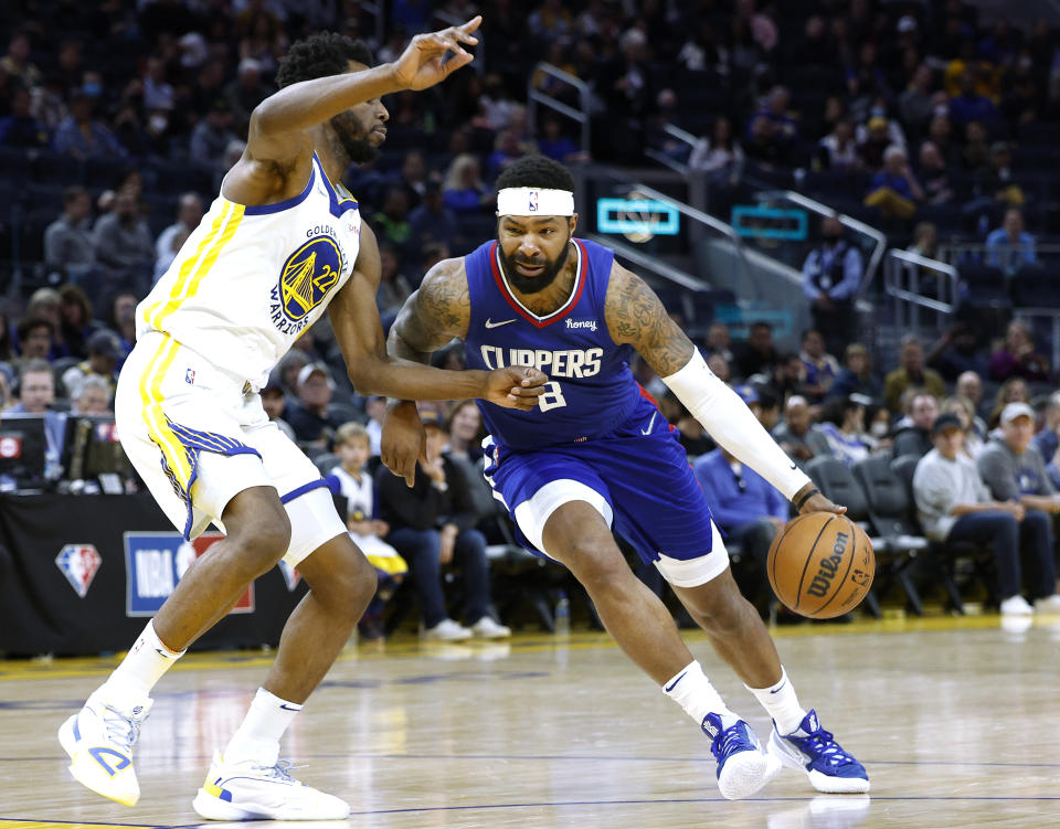 Marcus Morris Sr. of the Los Angeles Clippers drives towards the basket against Andrew Wiggins of the Golden State Warriors during an NBA game on March 8. (Thearon W. Henderson/Getty Images)