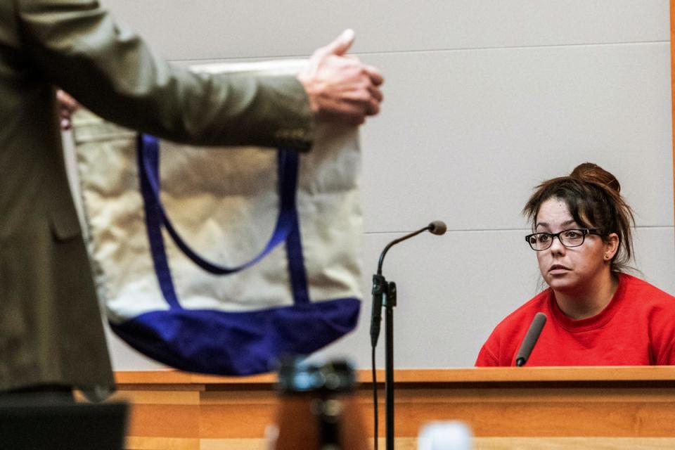 Kayla Montgomery is shown a tote bag while testifying during the trial of Adam Montgomery at Hillsborough County Superior Court, Monday Feb. 12, 2024, in Manchester (AP)
