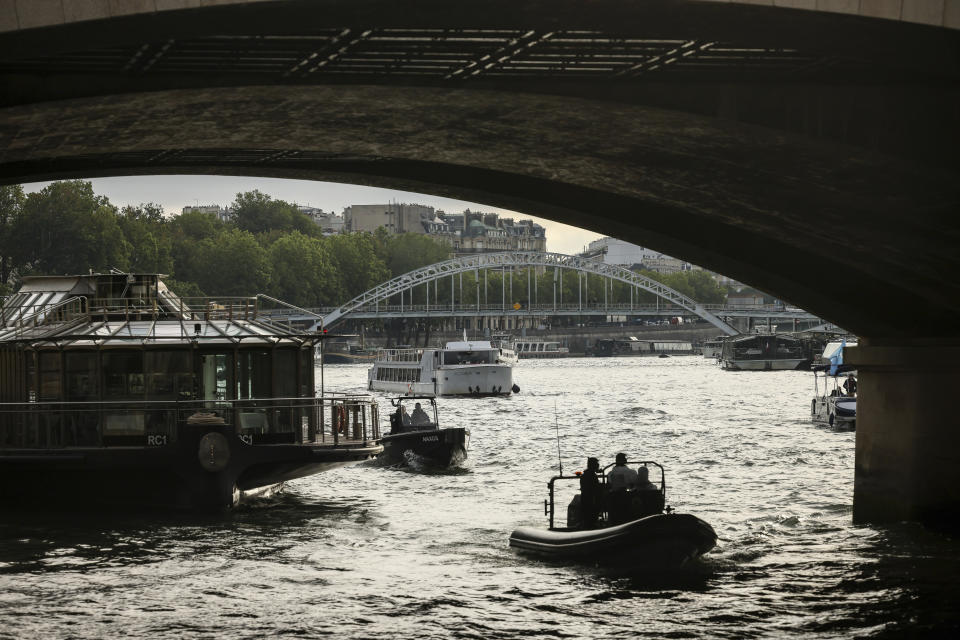 A police boat cruises on the Seine river during a rehearsal for the Paris 2024 Olympic Games opening ceremony, Monday, June. 17, 2024 in Paris. The river will host the Paris 2024 Olympic Games opening ceremony on July 26 with boats for each national delegation. (AP Photo/Thomas Padilla)