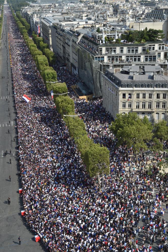 A huge crowd lines the Champs Élysées to welcome home the France team