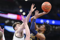 Notre Dame forward Carey Booth, right, shoots over Wake Forest center Matthew Marsh during the first half of an NCAA college basketball game in the second round of the Atlantic Coast Conference tournament, Wednesday, March 13, 2024, in Washington. (AP Photo/Nick Wass)