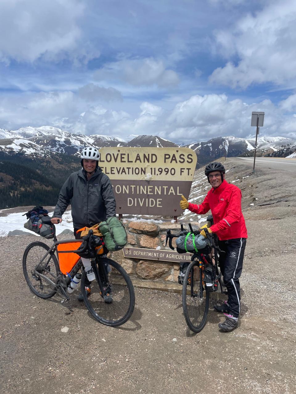 Sam and Chick Westby pose at the top of Loveland Pass, the highest point of their cross-country bike trip.