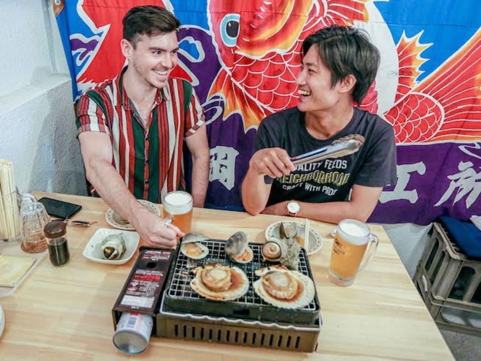 David McElhinney with friend eating a japanese meal together and smiling