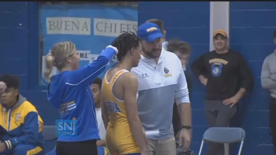 Andrew Johnson, a high school wrestler in New Jersey, was told to cut his dreadlocks or forfeit the match. (Screenshot)