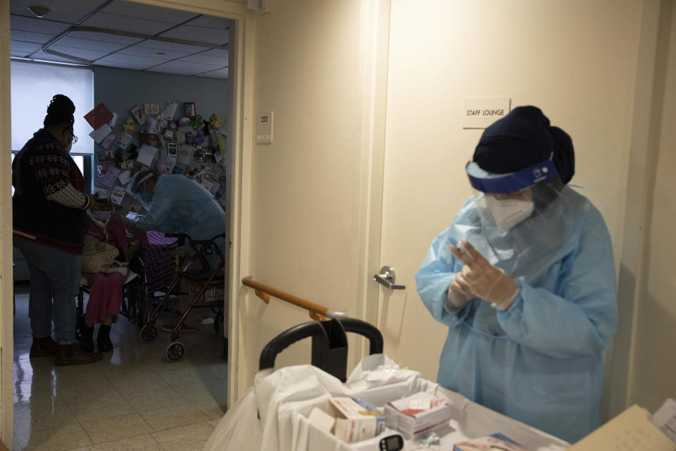 FILE - In this Jan. 15, 2021, file photo CVS Pharmacists prepare a shot of COVID-19 vaccine for the nursing home residents at Harlem Center for Nursing and Rehabilitation, a nursing home facility in Harlem neighborhood of New York. Nursing homes have to publicly disclose their vaccination rates for flu and pneumonia, but there’s no similar mandate for COVID-19 shots. (AP Photo/Yuki Iwamura, File)