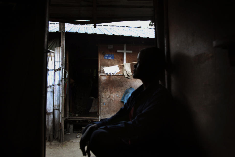 In this March 21, 2018, photo, Marip Lu sits in her family's shelter in a refugee camp in northern Kachin State, Myanmar. Marip Lu, 24, claims she was kidnapped by traffickers and suffered six years of captivity, rape and abuse deep in China. As the demand for "brides" in China rises, The Associated Press has pieced together the tragic ordeal of one woman who escaped, but had to leave her son behind. (AP Photo/Esther Htusan)