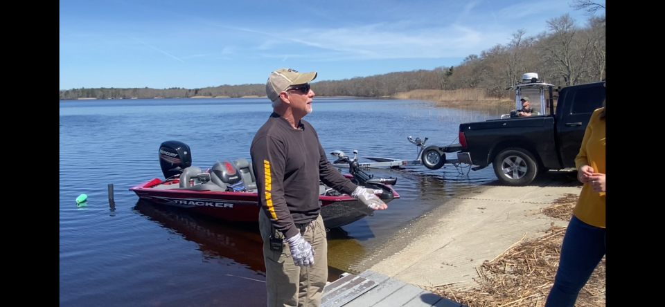 Robert Buscher, 62, of South Kingstown, intent on going fishing Tuesday morning on Worden Pond in South Kingstown, decided first to reel in two people whose helicopter crashed while testing sensors that measure elevation above the water. [Mark Reynolds/The Providence Journal]