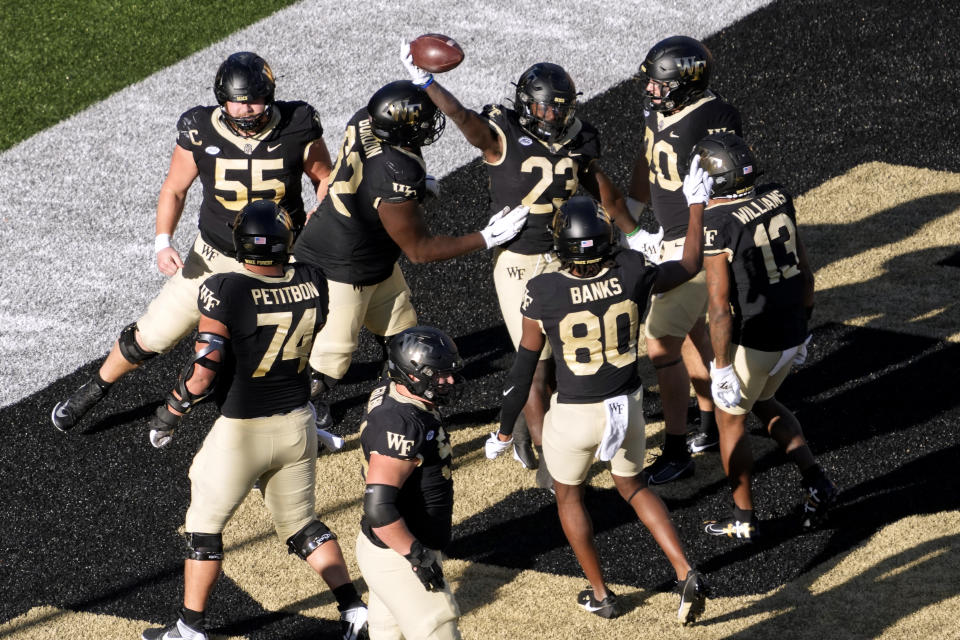 Wake Forest running back Demond Claiborne (23) celebrates his touchdown run against Pittsburgh during the first half of an NCAA college football game in Winston-Salem, N.C., Saturday, Oct. 21, 2023. (AP Photo/Chuck Burton)