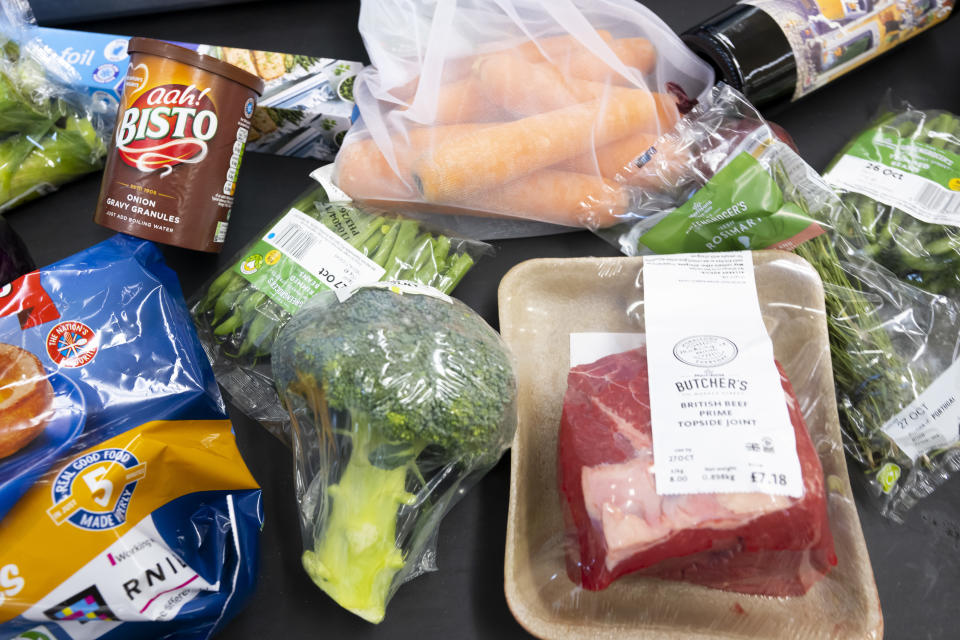 CARDIFF, WALES - OCTOBER 23: In this photo illustration, produce used in a traditional Sunday roast dinner is loaded onto a conveyor belt at the pay desk on October 23, 2022 in Cardiff, Wales. The cost of a home-cooked Sunday roast for a family of four has reached its highest level in over a decade with inflation at 10.1%. (Photo by Matthew Horwood/Getty Images)