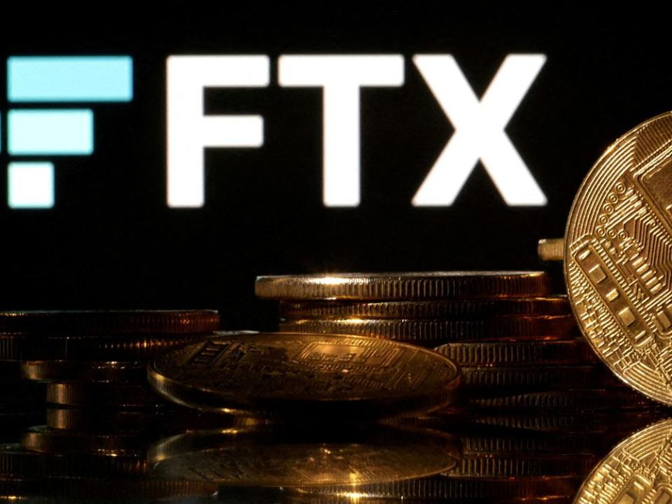 FILE PHOTO: Illustration shows FTX logo and representation of cryptocurrencies