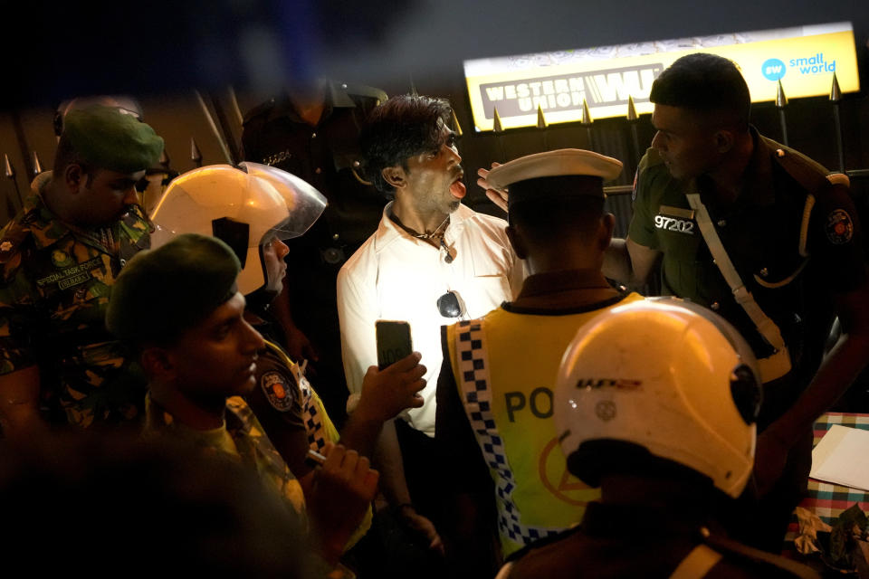 Sri Lankan police officers detain and question a suspected drug offender during a search operation against narcotics in Colombo, Sri Lanka, Thursday, Jan. 18, 2024. (AP Photo/Eranga Jayawardena)