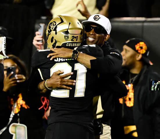 <p>Andy Cross/MediaNews Group/The Denver Post via Getty</p> olorado Buffaloes head coach Deion Sanders hugs his son, safety Shilo Sanders (21)