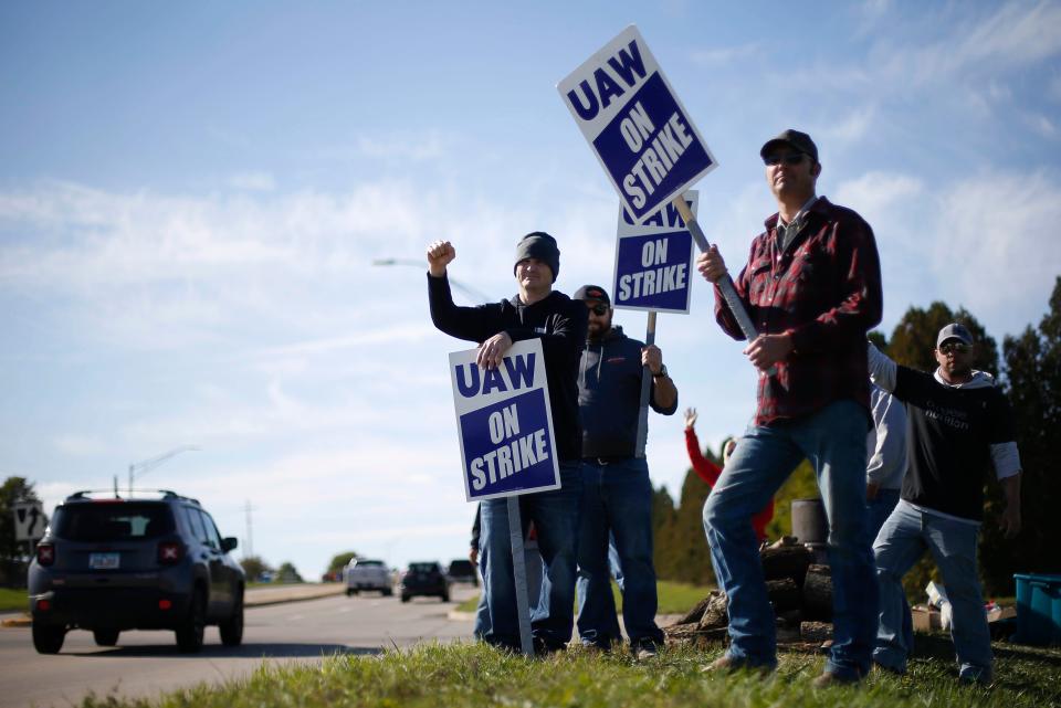 Members of the United Auto Workers strike outside of the John Deere Engine Works plant on Ridgeway Avenue in Waterloo.