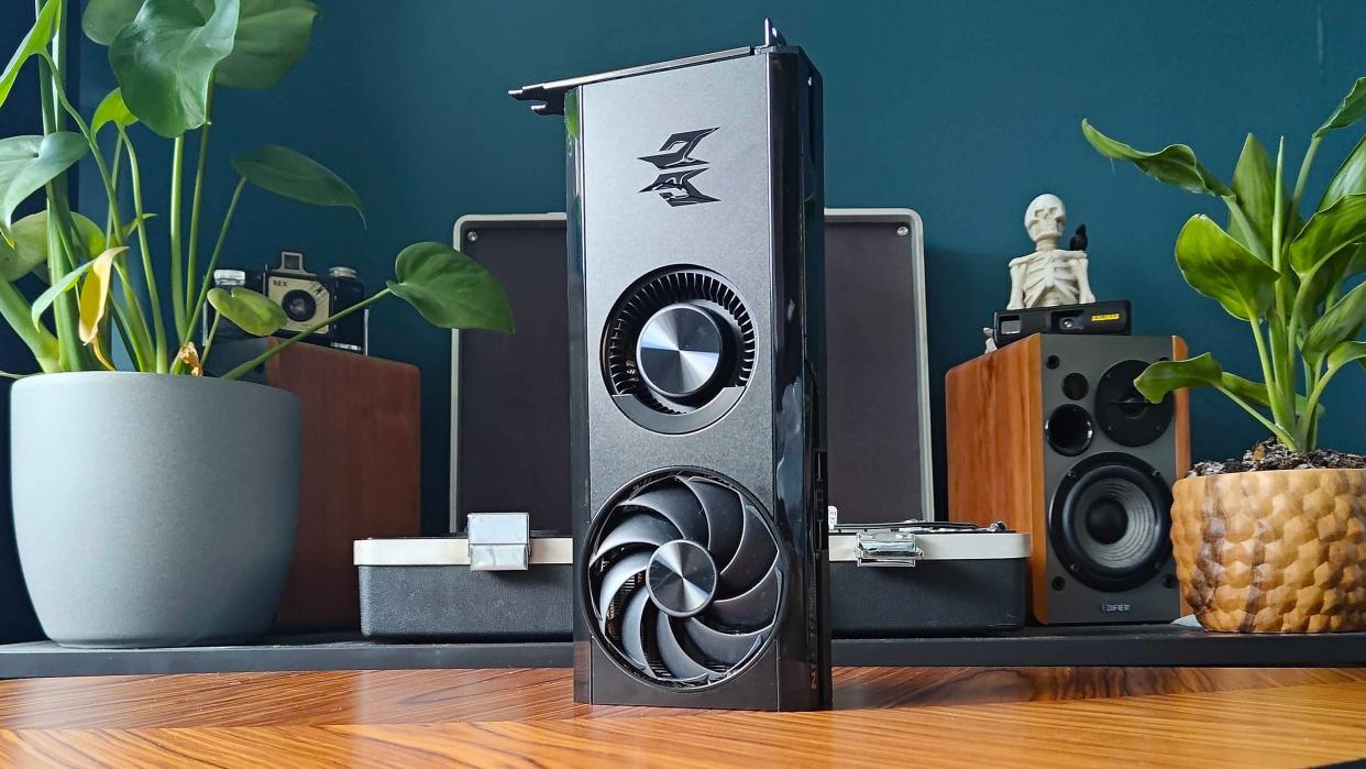  AMD Radeon RX 7600 graphics card sitting vertically upright on table. 