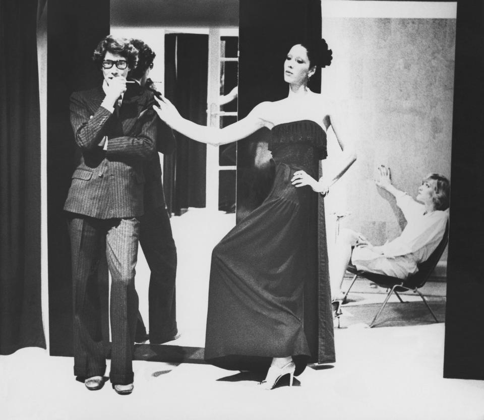 Yves Saint Laurent, with Marina Schiano in his designs. Loulou de la Falaise is seated far right.