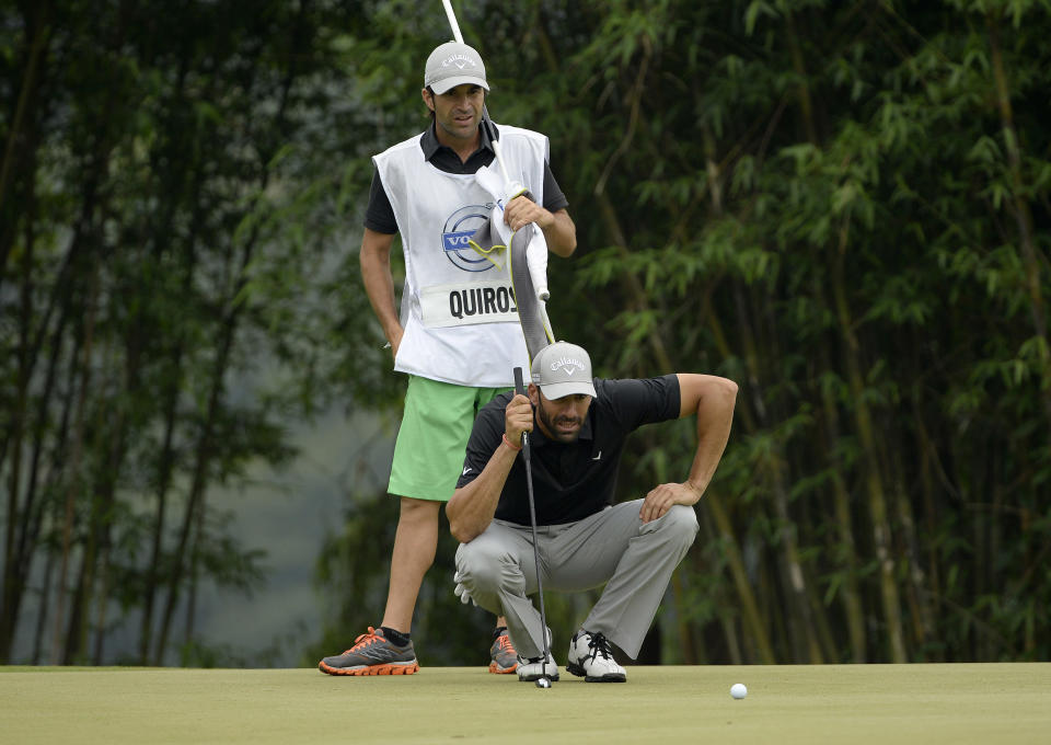 In this photo released by OneAsia, Alvaro Quiros of Spain lines up putt during the third round of the Volvo China Open at Genzon Golf Club in Shenzhen, southern China, Saturday, April 26, 2014. (AP Photo/OneAsia, Paul Lakatos) NO LICENSING