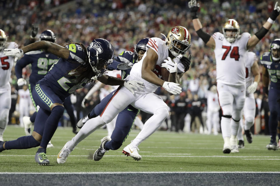 San Francisco 49ers' Raheem Mostert scores against the Seattle Seahawks during the second half of an NFL football game, Sunday, Dec. 29, 2019, in Seattle. (AP Photo/Ted S. Warren)
