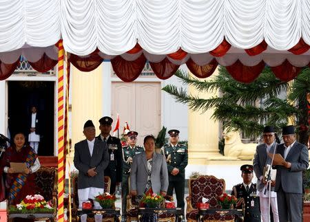 Nepal's President Bidhya Devi Bhandari (L) administers the oath of office to the newly-elected Prime Minister Pushpa Kamal Dahal (R), also known as Prachanda, in the presence of outgoing Prime Minister Khadga Prasad Sharma Oli (2nd L) and Constituent Assembly chairperson Onsari Gharti Magar (3rd L) at the presidential building "Shital Niwas" in Kathmandu, Nepal August 4, 2016. REUTERS/Navesh Chitrakar