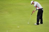 Adam Scott of Australia putting on the 13th green during his first round on the opening day of the 2012 Open Championship at Royal Lytham & St Anne's in Lytham