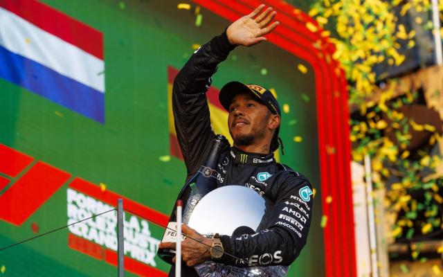 Mercedes AMG Petronas driver Lewis Hamilton on the podium - Shutterstock/Stephen Blackberry