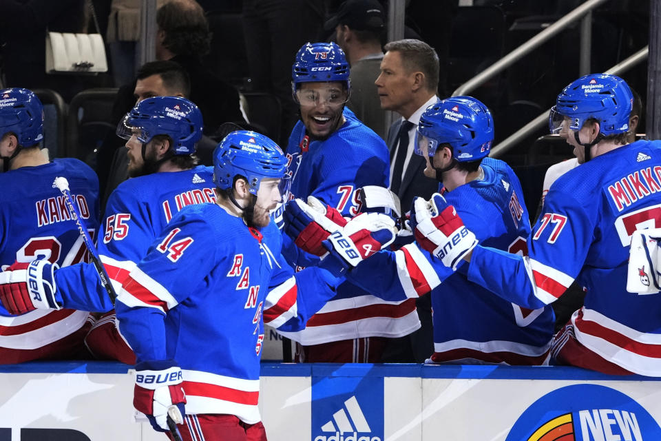 New York Rangers' Tyler Motte (14) celebrates with teammates after scoring a goal against the Tampa Bay Lightning during the first period of an NHL hockey game Wednesday, April 5, 2023, in New York. (AP Photo/Frank Franklin II)