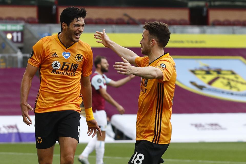 Wolverhampton Wanderers' Mexican striker Raul Jimenez (L) is congratulated by Wolverhampton Wanderers' Portuguese midfielder Diogo Jota after scoring a goal during the English Premier League football match between Burnley and Wolverhampton Wanderers at Turf Moor in Burnley, north-west England on July 15, 2020. (Photo by JASON CAIRNDUFF / POOL / AFP) / RESTRICTED TO EDITORIAL USE. No use with unauthorized audio, video, data, fixture lists, club/league logos or 'live' services. Online in-match use limited to 120 images. An additional 40 images may be used in extra time. No video emulation. Social media in-match use limited to 120 images. An additional 40 images may be used in extra time. No use in betting publications, games or single club/league/player publications. /  (Photo by JASON CAIRNDUFF/POOL/AFP via Getty Images)