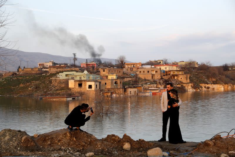 People pose for a souvenir photo by the Tigris River in Hasankeyf