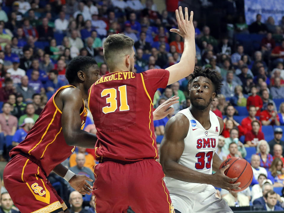 Southern California's Chimezie Metu, left, and Nick Rakocevic (31) defend as SMU's Semi Ojeleye (33) positions for a shot in the first half of a first-round game in the men's NCAA college basketball tournament in Tulsa, Okla., Friday March 17, 2017. (AP Photo/Tony Gutierrez)