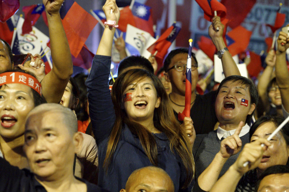 Supporters of the opposition Nationalist Party celebrate in Kaohsiung, Taiwan, Saturday, Nov. 24, 2018. Taiwan's ruling party suffered a major defeat Saturday in local elections seen as a referendum on the administration of the island's independence-leaning president amid growing economic and political pressure from China. (AP Photo)