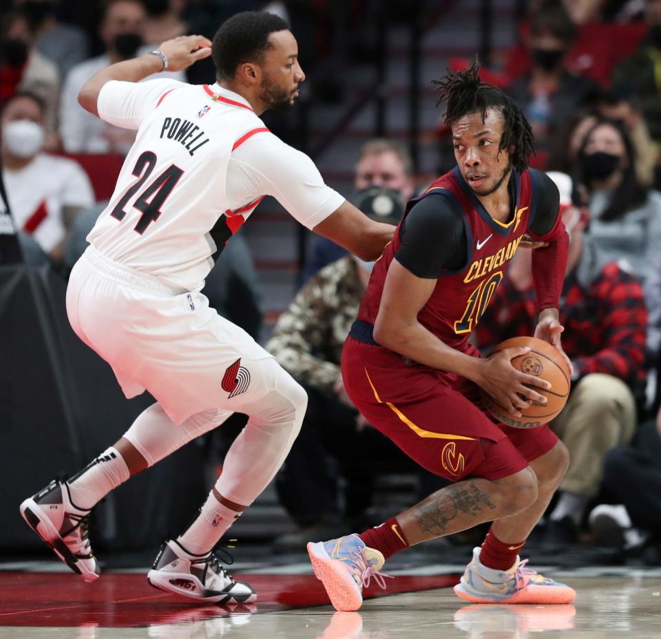 Portland Trail Blazers forward Norman Powell, left, guards Cavaliers guard Darius Garland during the first half of Friday night's NBA game. The Cavaliers won 114-101. [Amanda Loman/Associated Press]