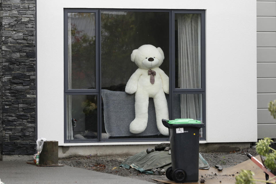 In this Monday, March 30, 2020, photo, a teddy bear sits in a window of a house in Christchurch, New Zealand. New Zealanders are embracing an international movement in which people are placing teddy bears in their windows during coronavirus lockdowns to brighten the mood and give children a game to play by spotting the bears in their neighborhoods. (AP Photo/Mark Baker)