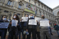 Restaurants and bars owners protest against the government restriction measures to curb the spread of COVID-19, in front of the Milan city hall, Italy, Tuesday, Oct. 27, 2020. Italy's leader has imposed at least a month of new restrictions to fight rising coronavirus infections, shutting down gyms, pools and movie theaters and putting an early curfew on cafes and restaurants. (AP Photo/Luca Bruno)