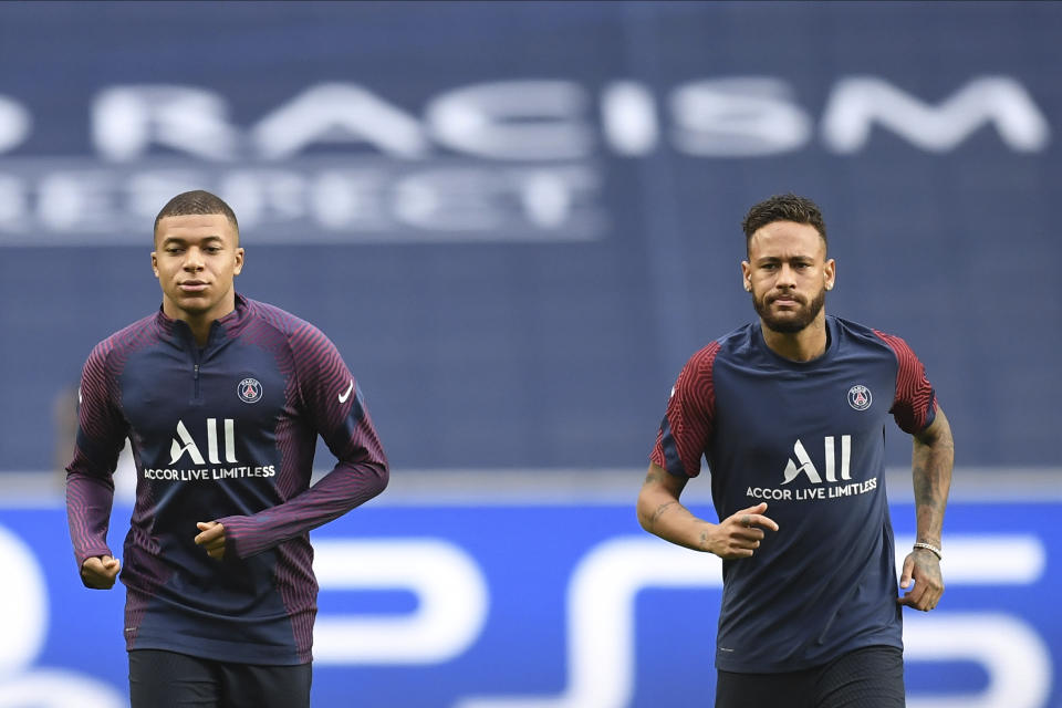 PSG's Neymar, right, and Kylian Mbappe exercise during a training session at the Luz stadium in Lisbon, Tuesday Aug. 11, 2020. PSG will play Atalanta in a Champions League quarterfinals soccer match on Wednesday. (David Ramos/Pool via AP)