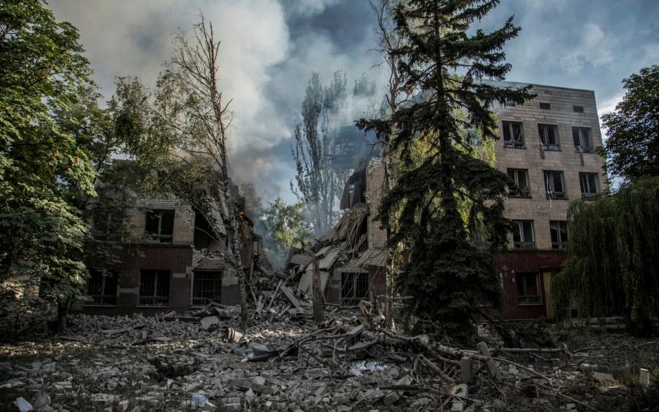 Smoke rises over the remains of a building destroyed by a military strike, as Russia's attack on Ukraine continues in Lysychansk - Reuters